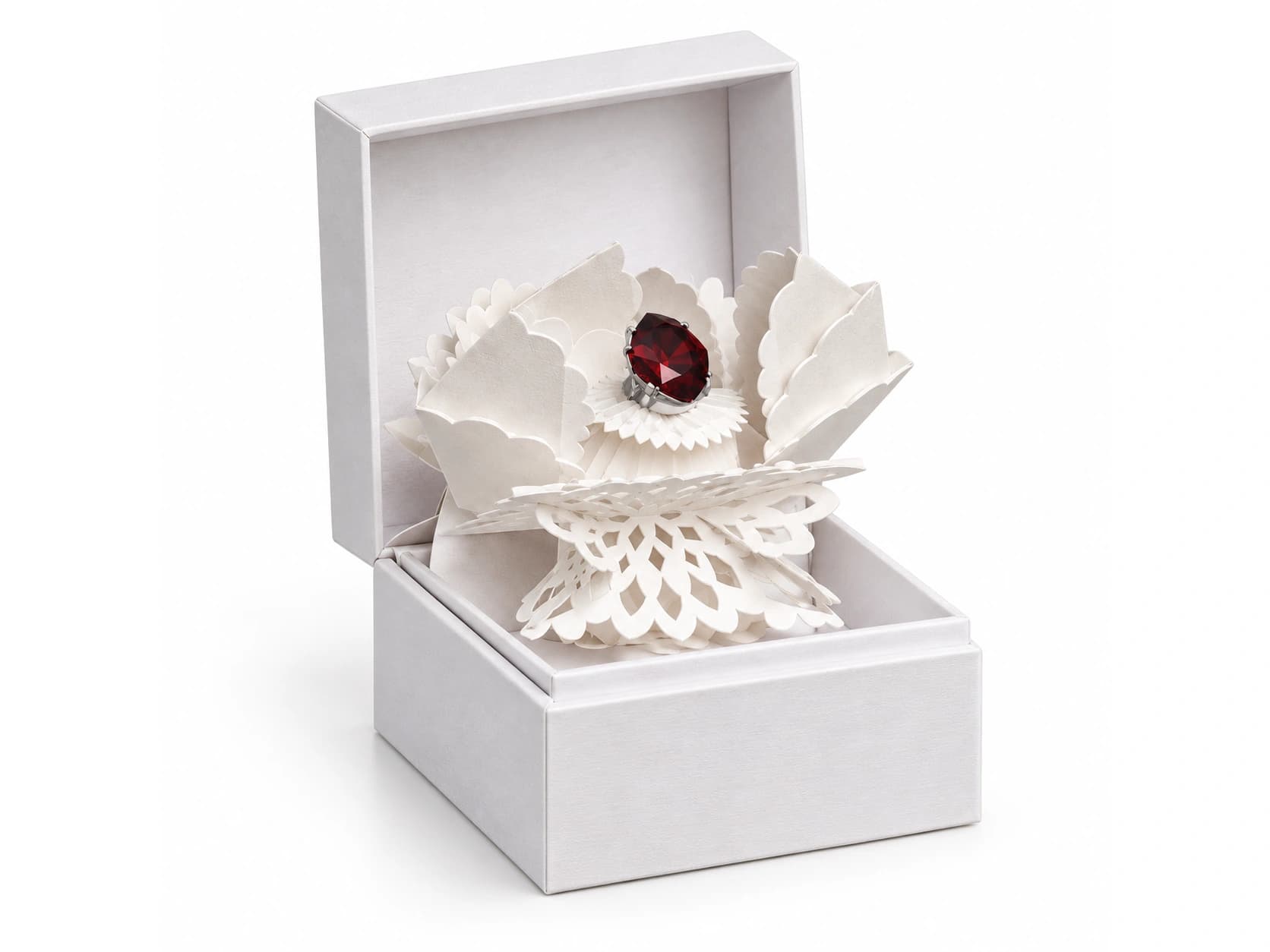White hinged box with layered floral paper forms surrounding a red featured item