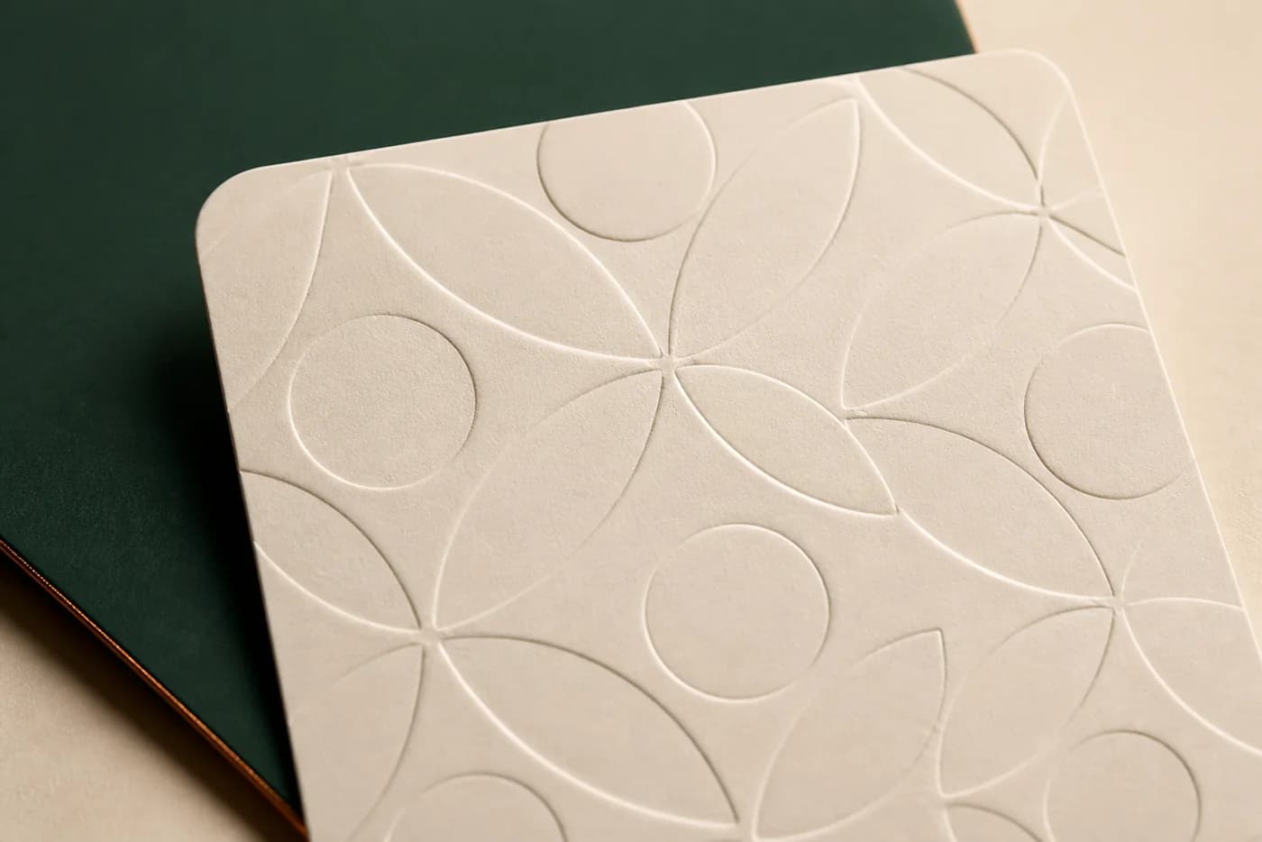 Raised embossed pattern on cream paperboard